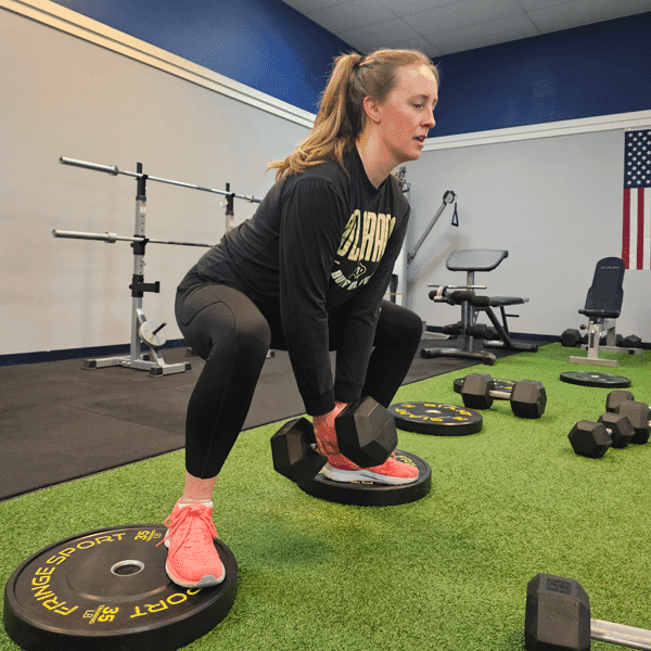 A Full30Fit member strength training with dumbbells.
